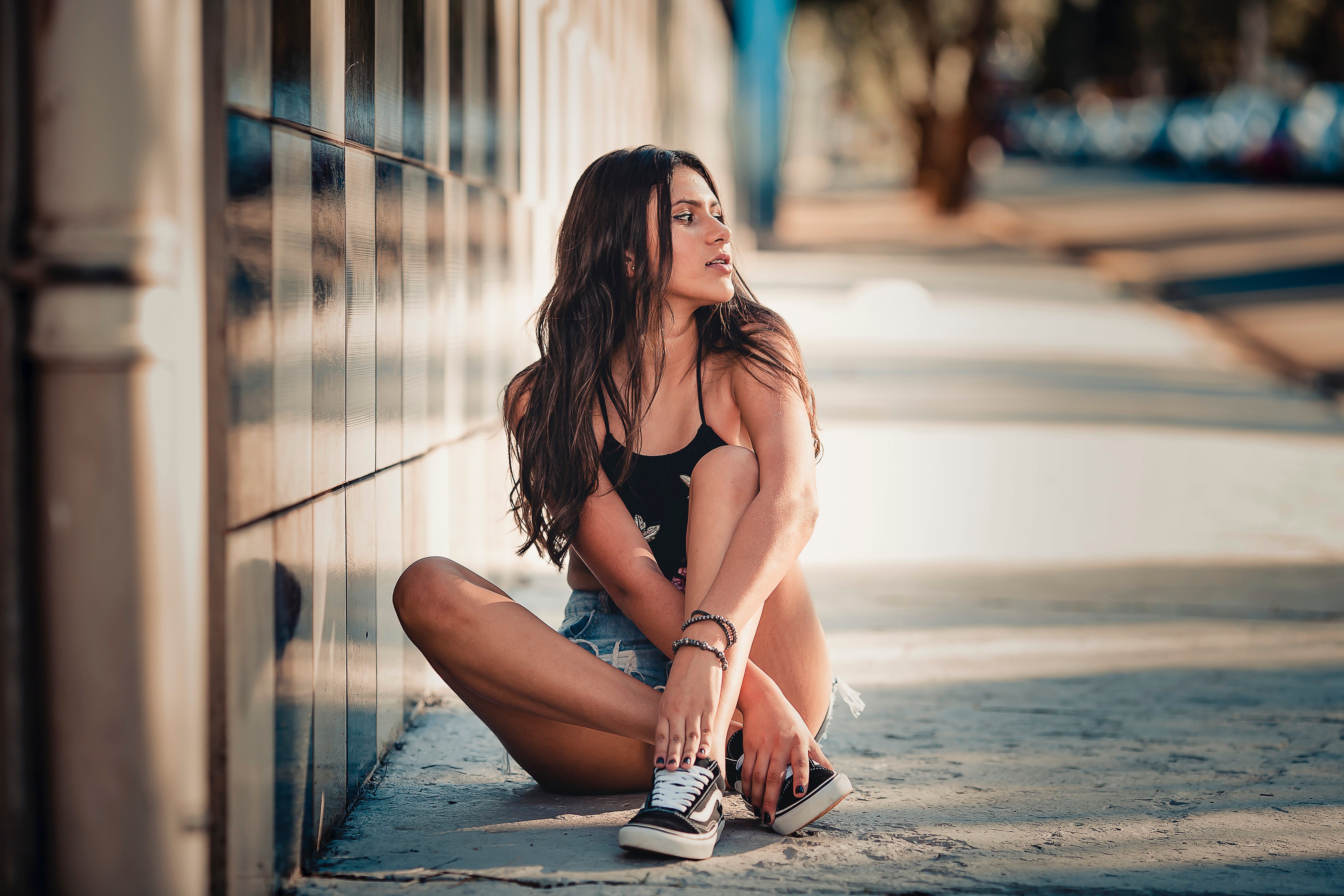 Girl sitting down on a street and posing
