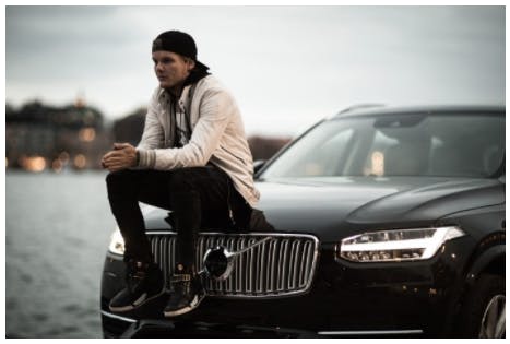 Tim 'Avicii' Bergling sitting on a Volvo with Stockholm in the background
